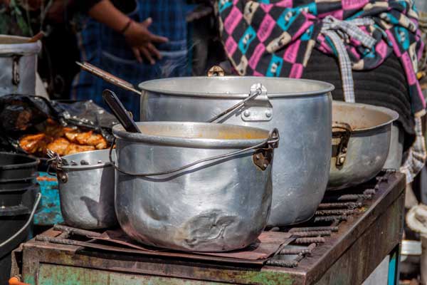 Cooking pots of the eatery at a traditional Saturday market in a remote village Zumbahua, Ecuador