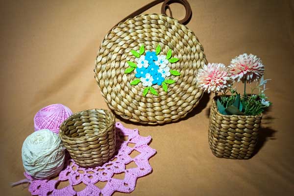 Baskets, yarns, flower basket, and bag with floral design made from woven dried water hyacinth