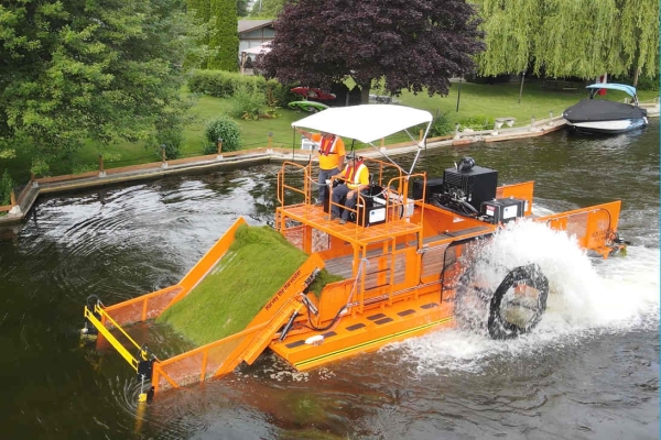 Ramara Canada HM-620 Orange aquatic weed harvester cutting and removing submerged aquatic weeds in Canada.